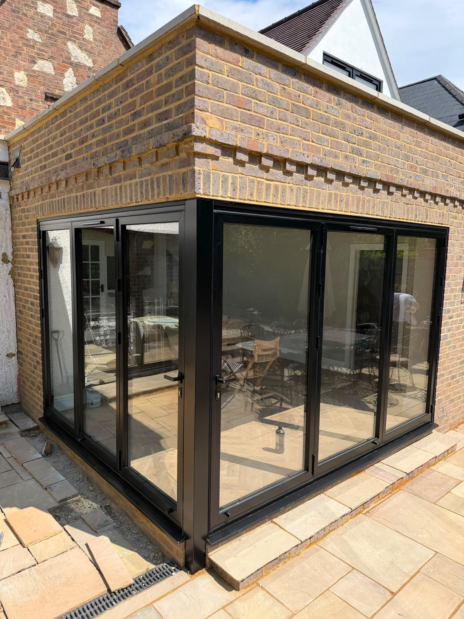 Rear extension with brickwork and black-framed bi-fold doors