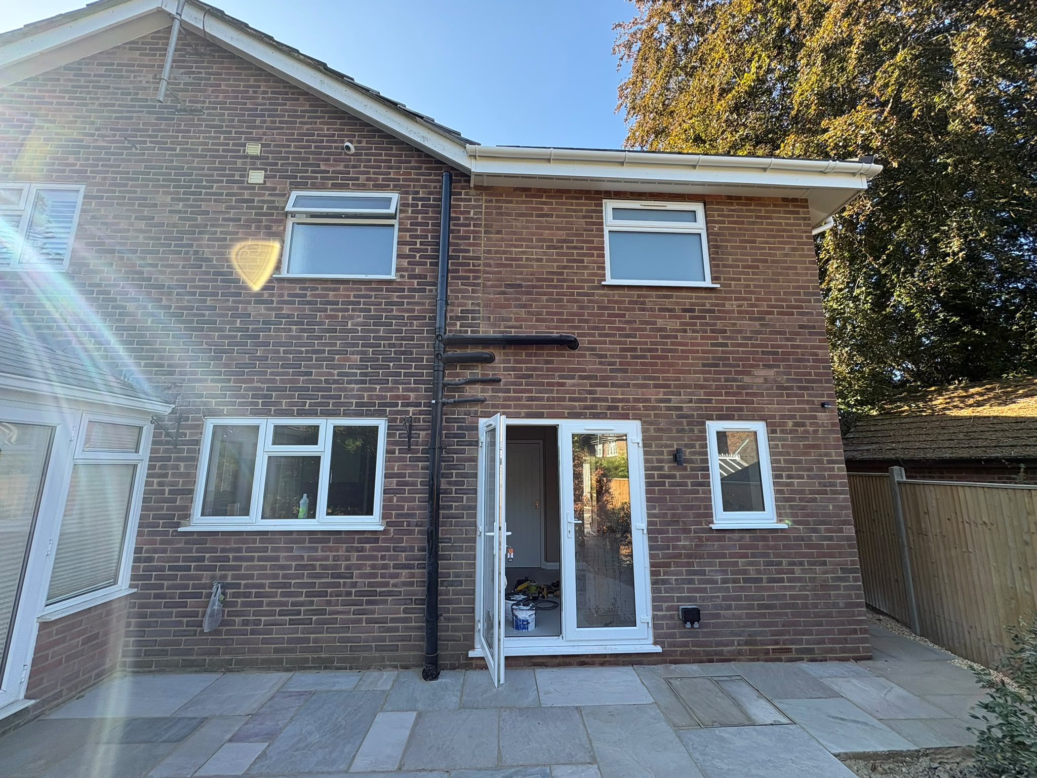 Brick house extension with a new upper storey and garden entrance